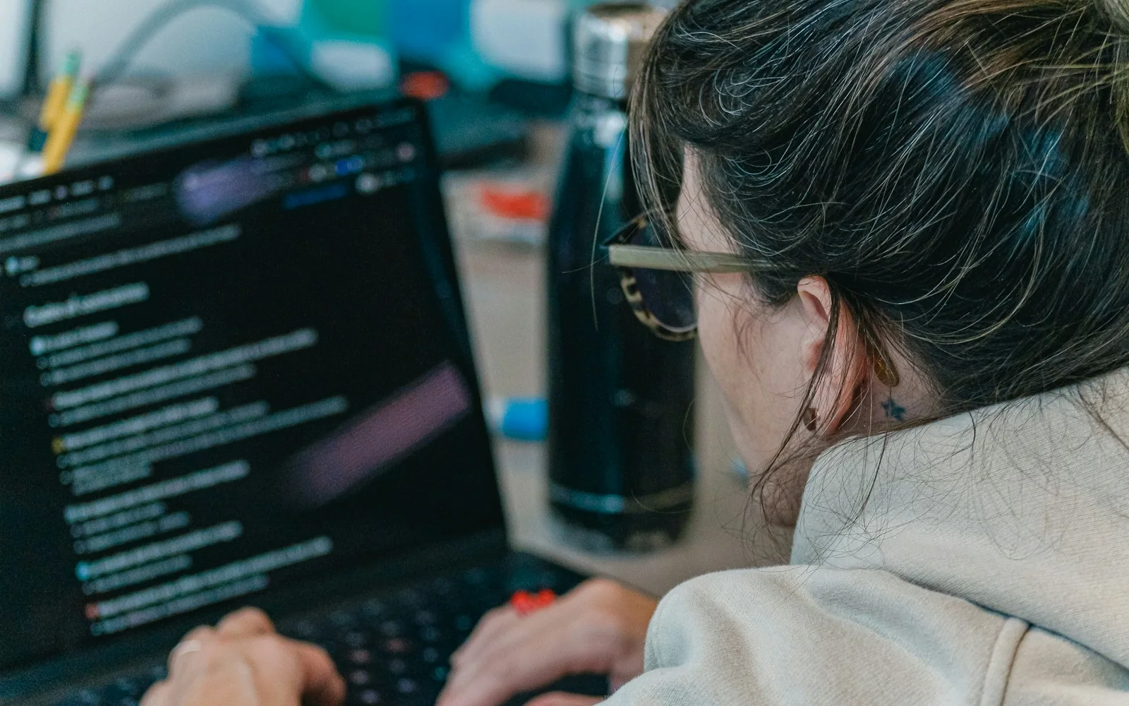 Remote developer writing code on a laptop