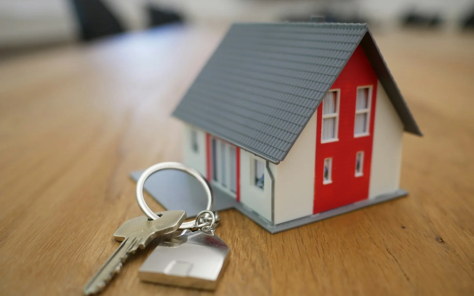 Miniature house model representing real estate website design