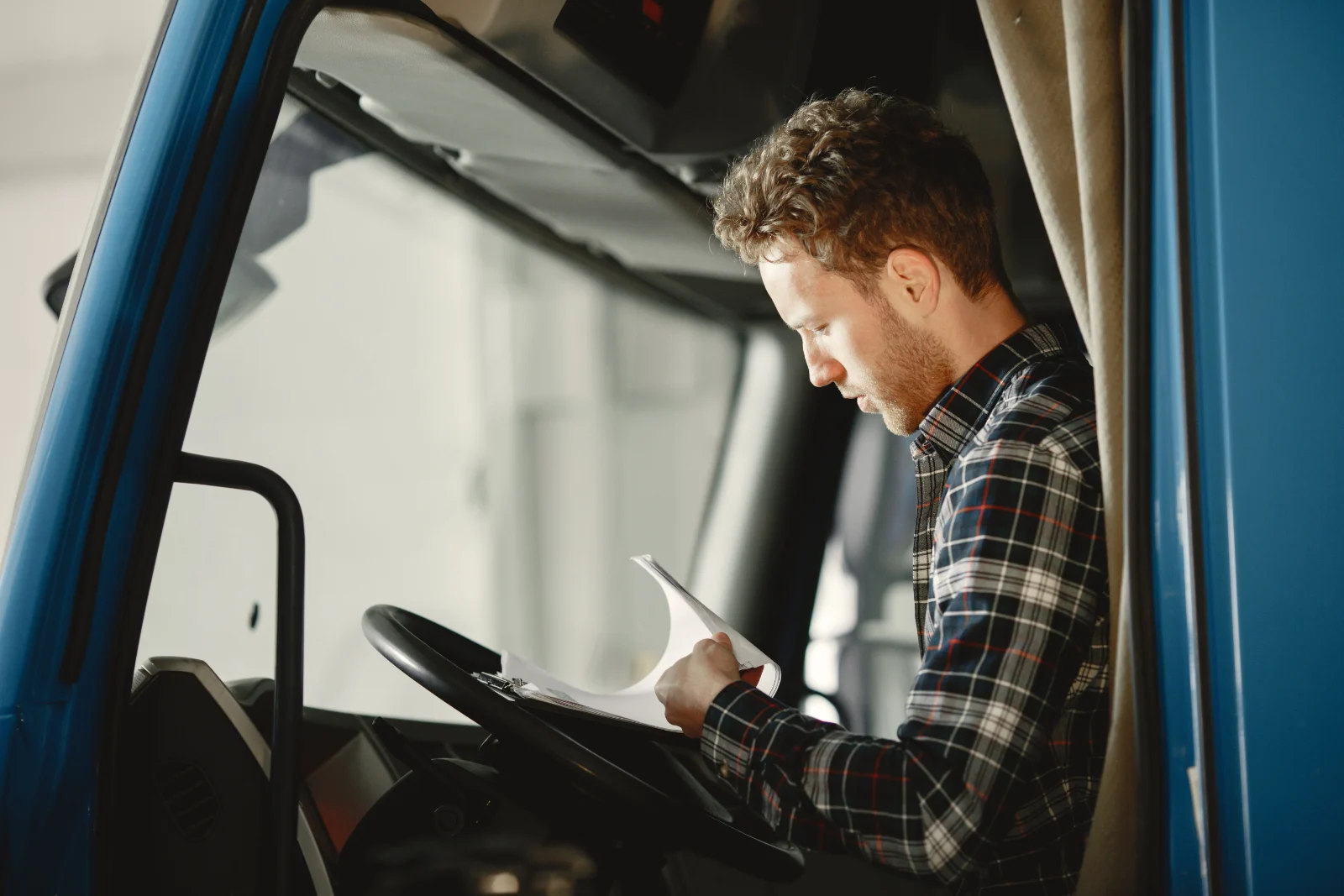 Owner-operator truck driver checking loads booked by a dispatcher