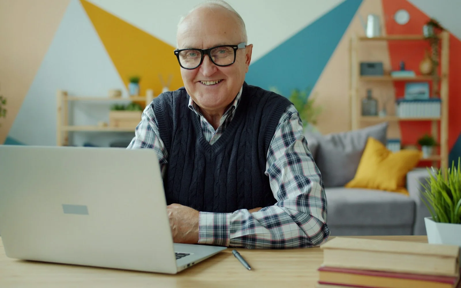 Smiling older man using a laptop, representing accessible website design